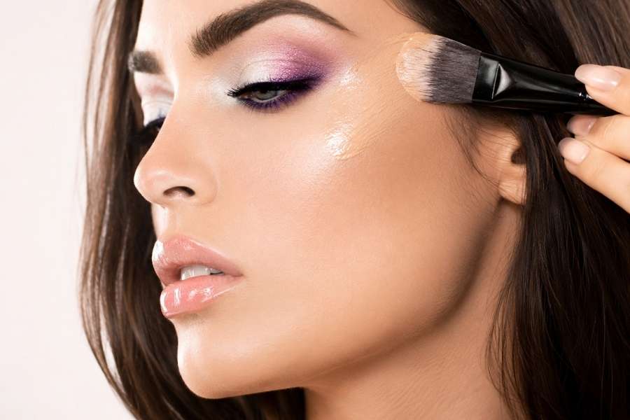 Application de fond de teint au pinceau pour structurer son visage avec précision.